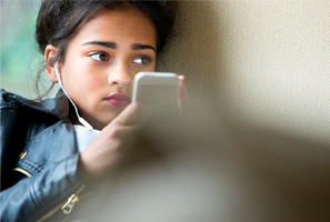 female student forlorn expression while looking at mobile phone