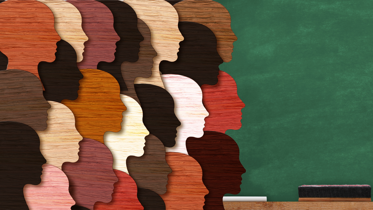 diverse colors of head silhouettes on top of chalkboard